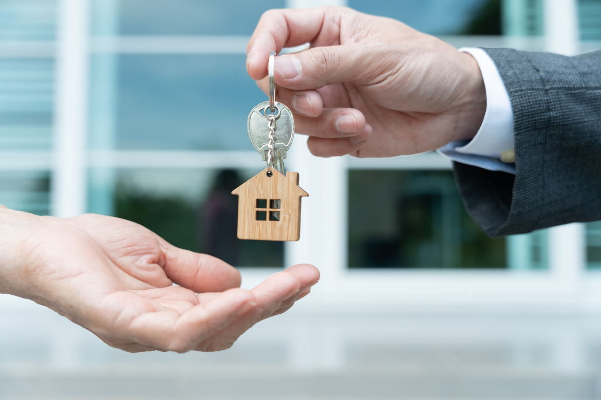 Real estate manager handing keys to new owner